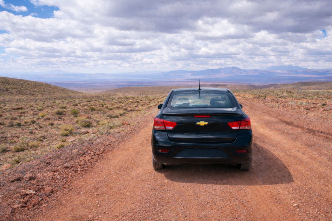 Black car navigating an off-road trail in the Atacama Desert as part of a private Atacama Chile Tours experience